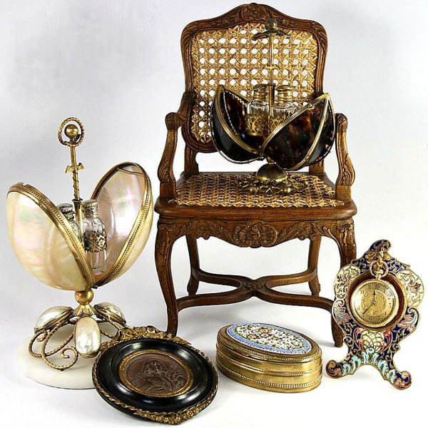 mix of antique items, cane wood chair, clock, frame, enamel container, and 2 clamshell liquor containers.